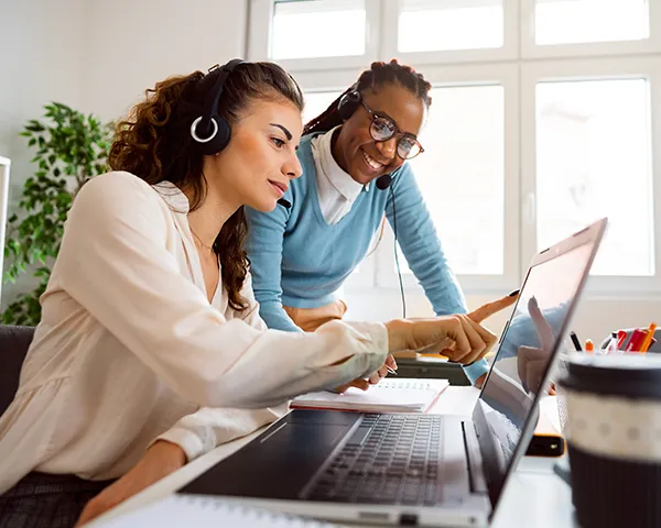 An on-call team at their desks assisting clients over the phone.