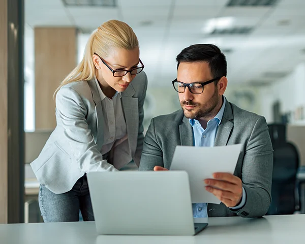 A female and male attorney going over documents.